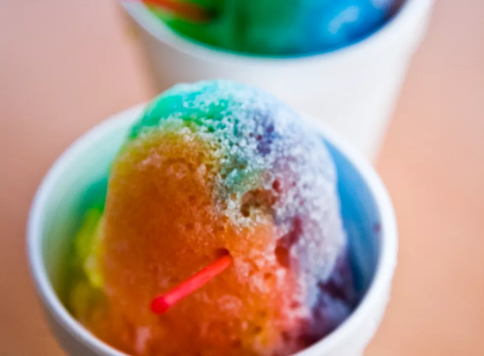 Two cups of colorful shaved ice.