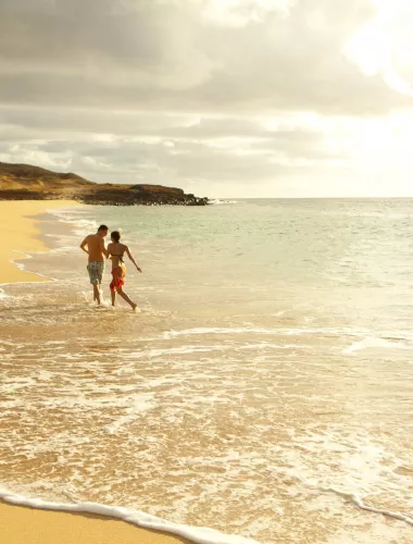A couple wading on the coast of Molokai