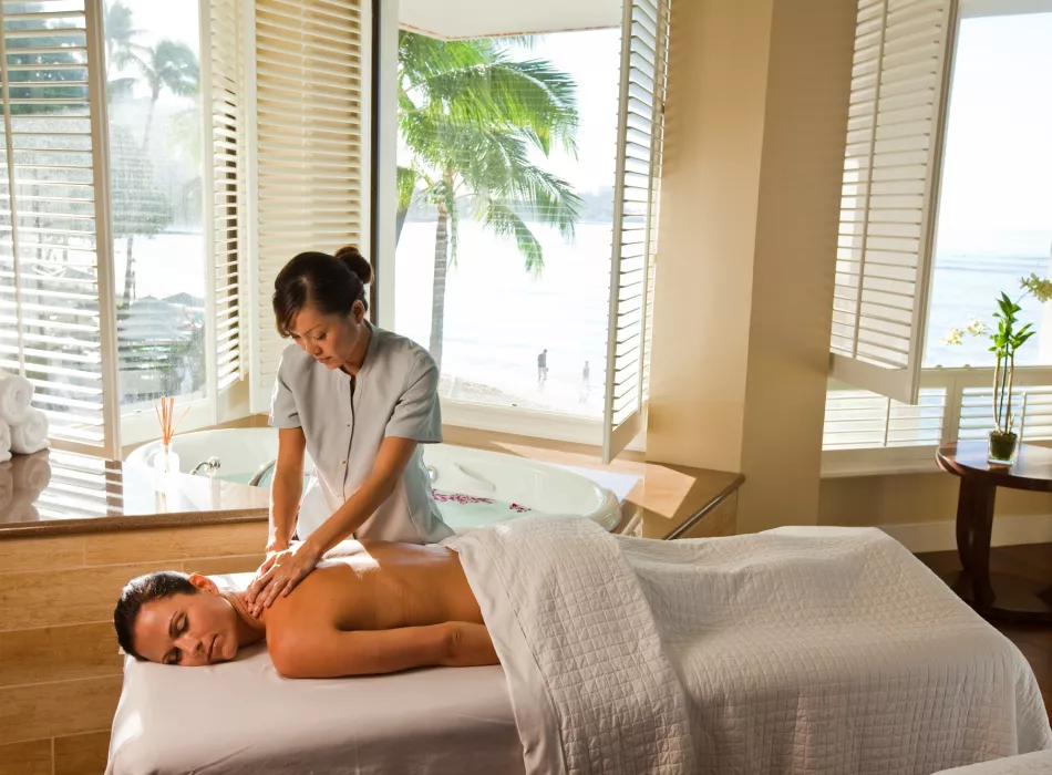 A therapist giving a woman a back massage.
